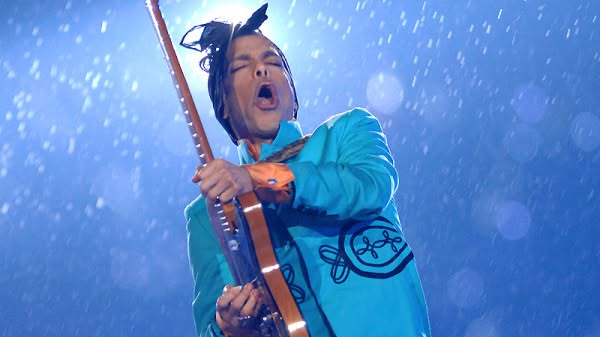 Prince performing "Purple Rain" in a heavy downpour during the Super Bowl XLI halftime show.